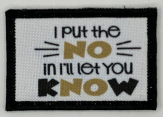 a white and black patch with a quote on it