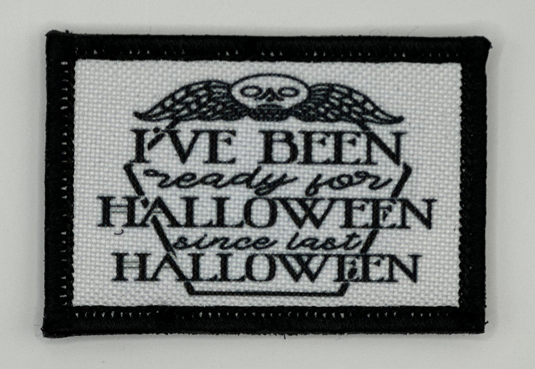 a black and white embroidered patch with a quote on it