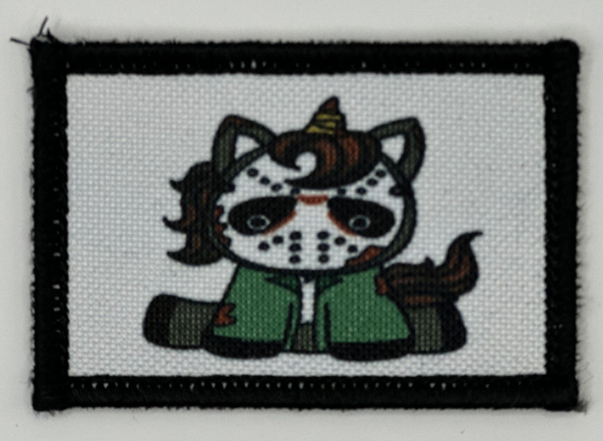 a cross stitch picture of a cat wearing a costume