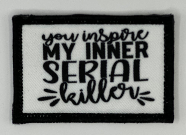 a black and white patch with the words you inspire my inner serial killer