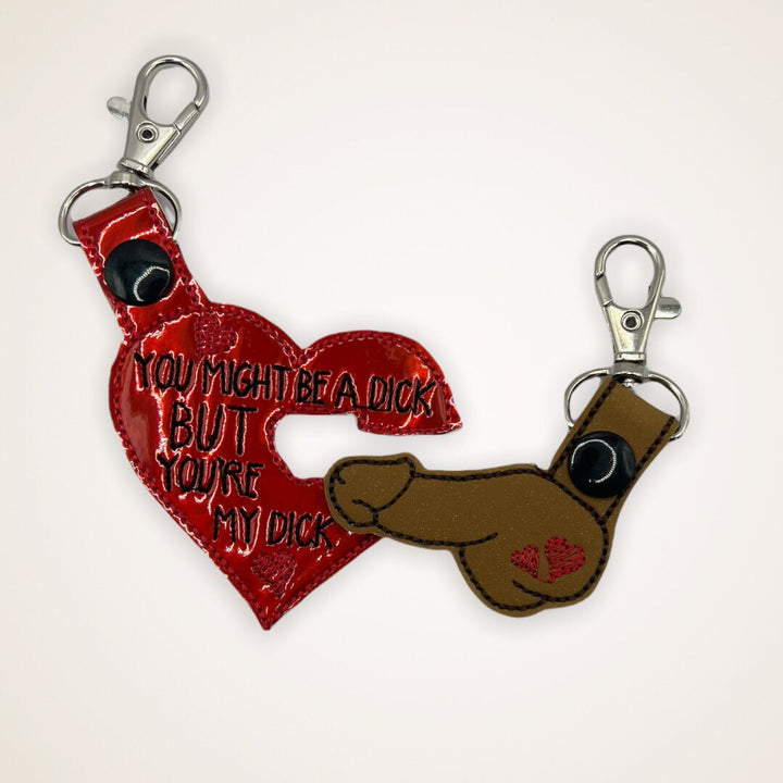 a red heart shaped keychain with the words you might be a dick but you&#39;re my dick