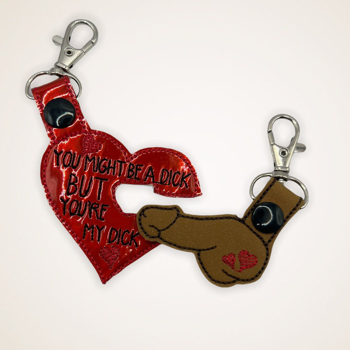 a red heart shaped keychain with the words you might be a dick but you&#39;re my dick