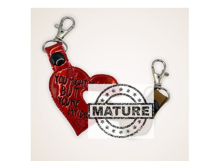 a red heart shaped keychain with the words you might be a dick but you&#39;re my dick