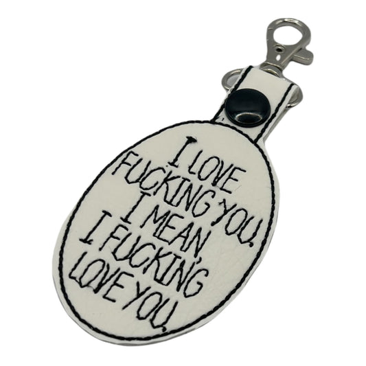 a key chain with I love fucking you, I mean I fucking love you