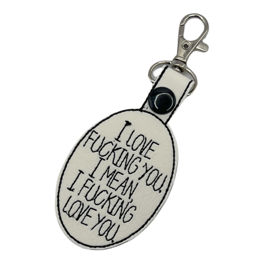 a key chain with I love fucking you, I mean I fucking love you