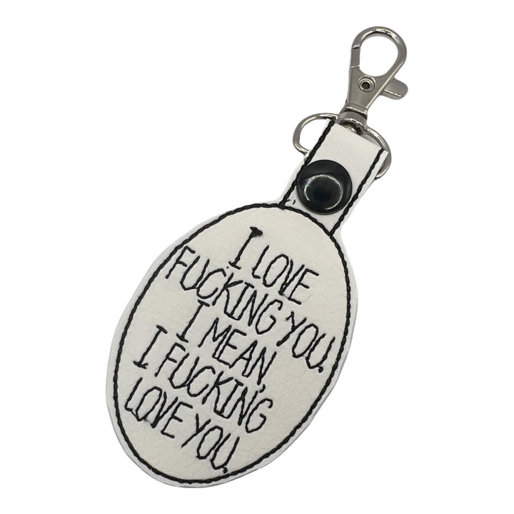 a key chain with I love fucking you, I mean I fucking love you