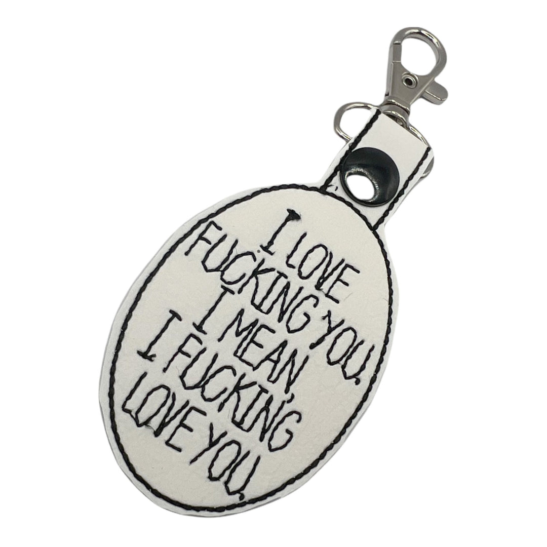 a key chain with I love fucking you, I mean I fucking love you