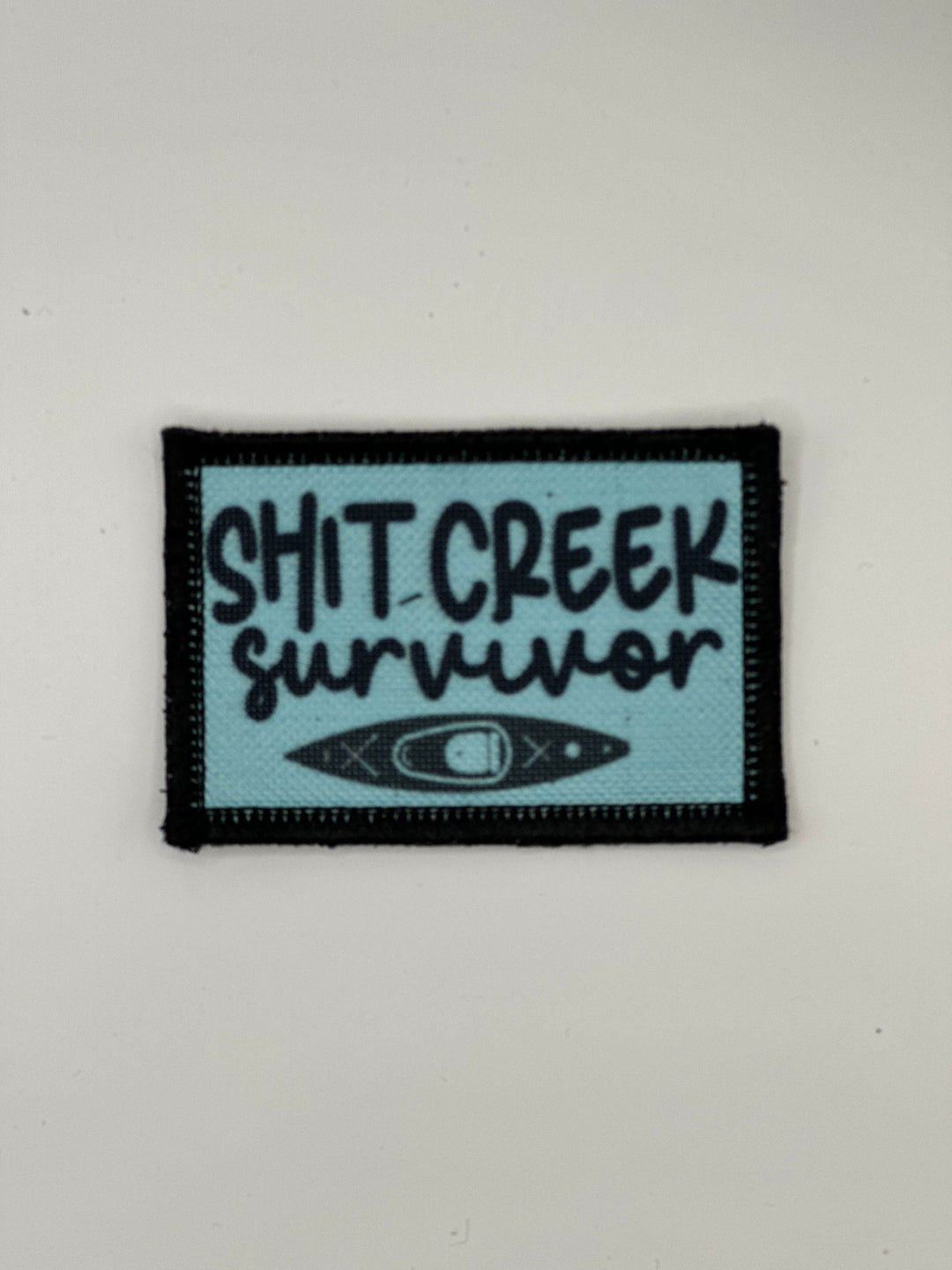 a patch that says shit creek survivor on it