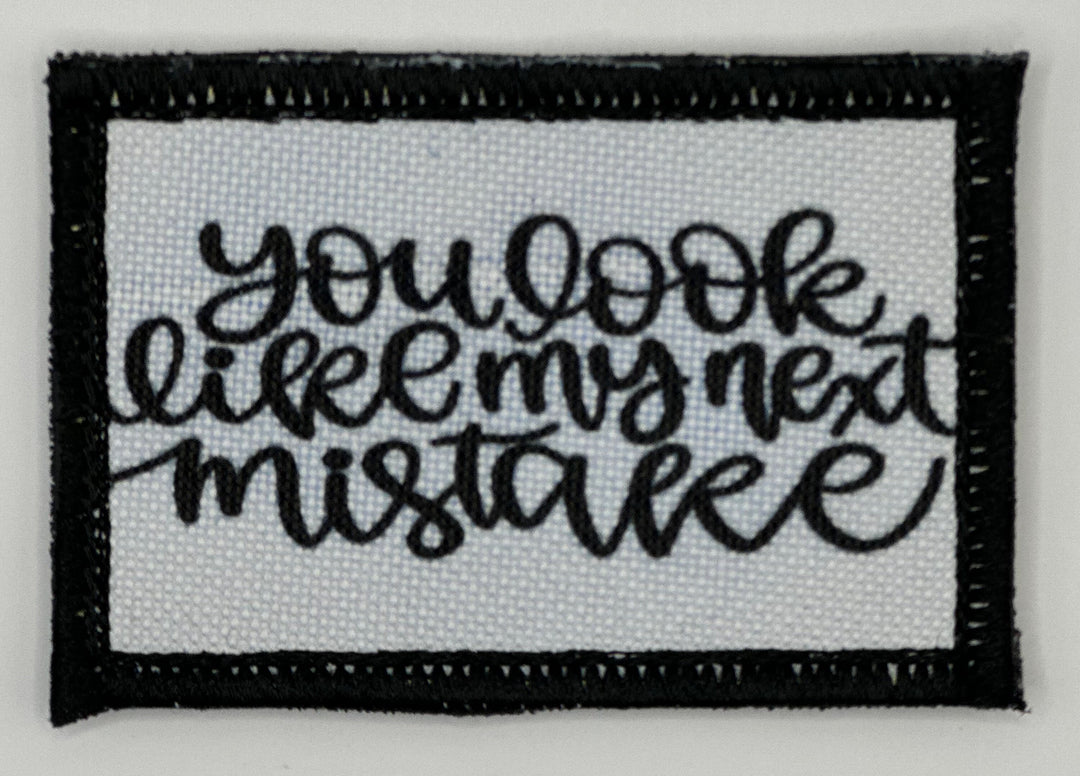 a black and white embroidered patch with the words you look like i&#39;m not