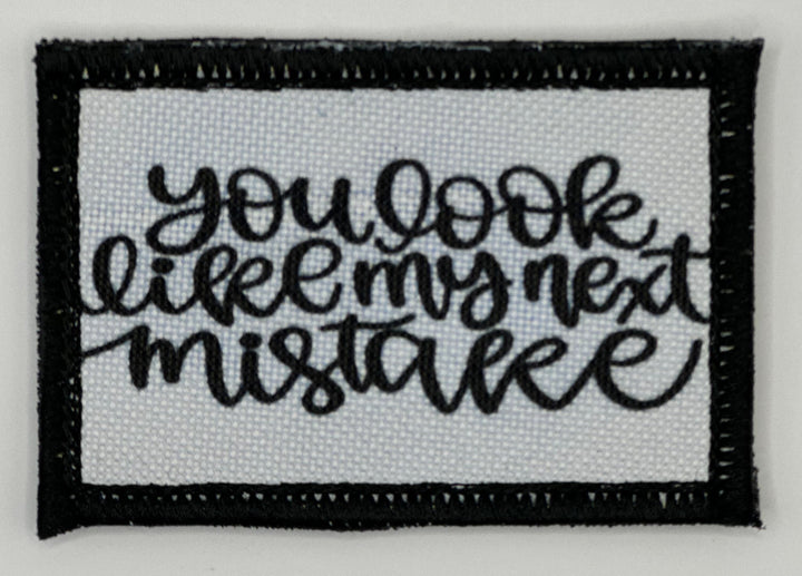 a black and white embroidered patch with the words you look like i&#39;m not