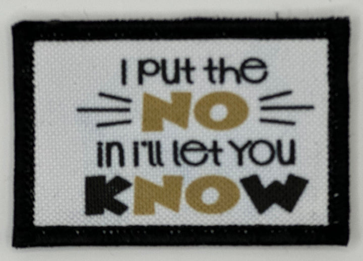 a white and black patch with a quote on it