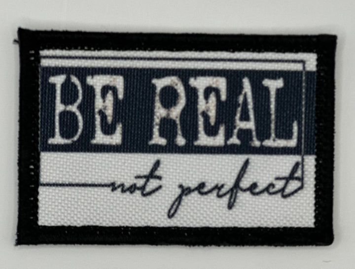 a black and white patch with the words be regal not perfect