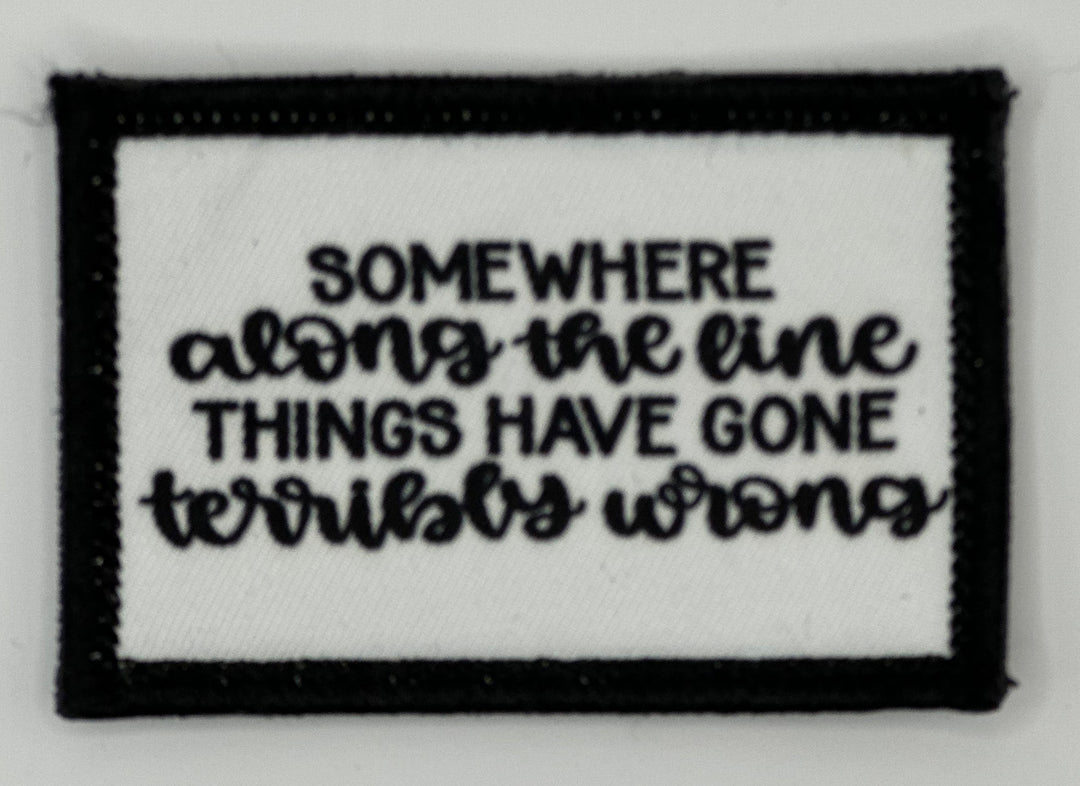 a black and white patch with a quote on it