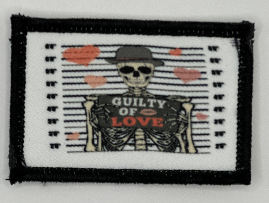 a patch with a skeleton holding a sign that says quality of love