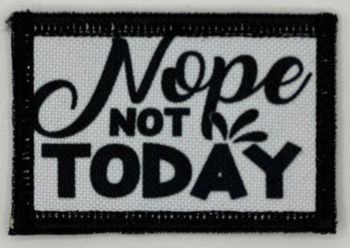 a black and white patch that says nope not today