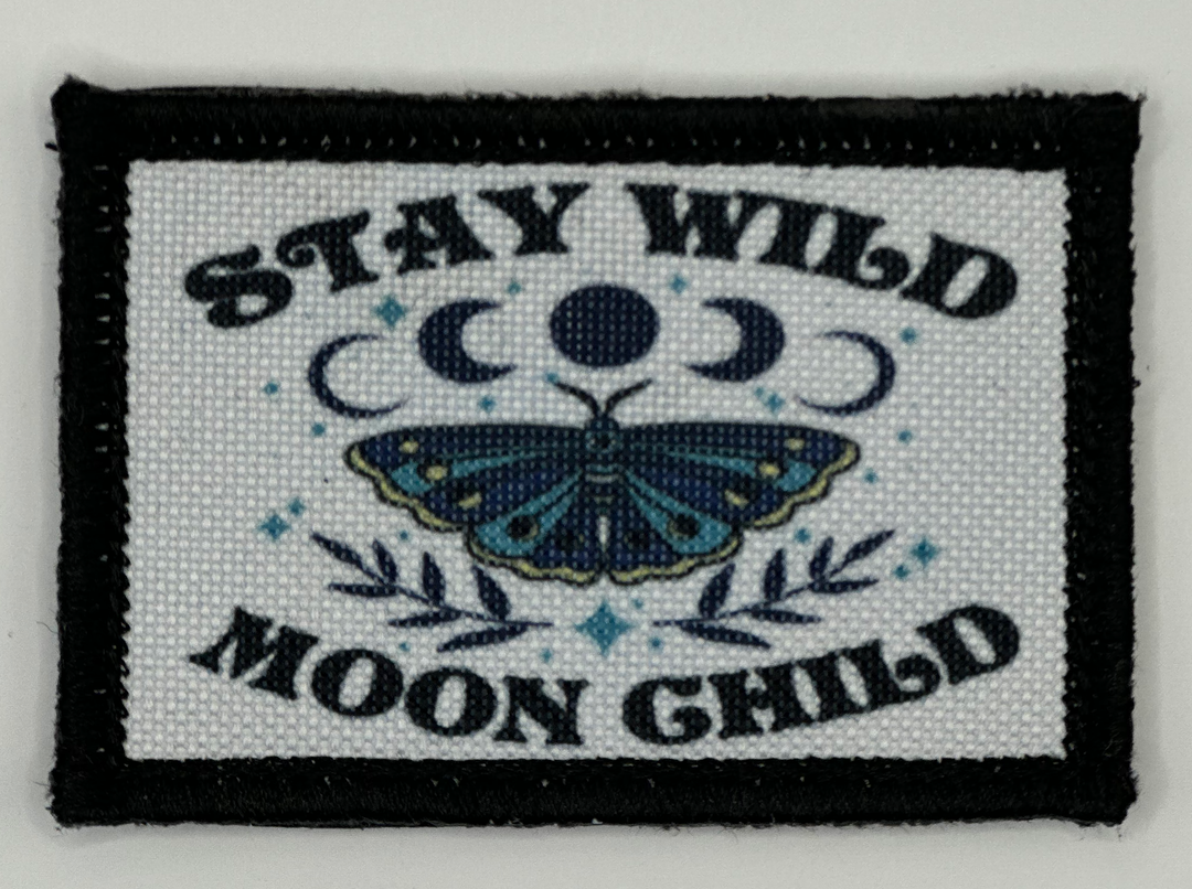 a black and white patch with a blue butterfly on it