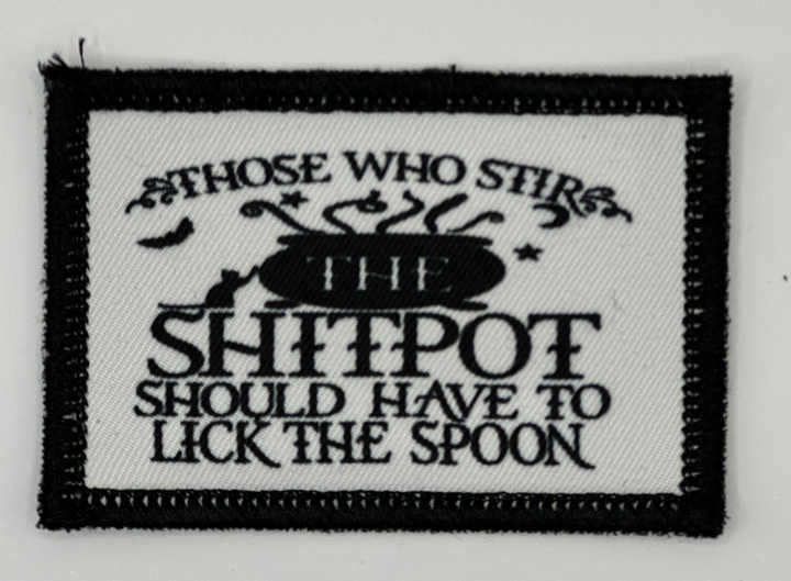 a black and white patch with a quote on it