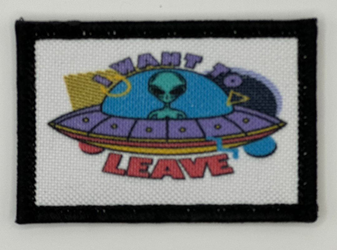 a patch with an alien on it that says want to leave