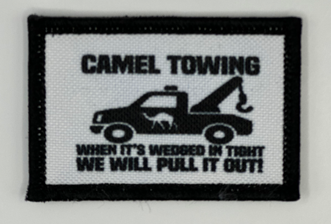 a black and white patch with a picture of a tow truck