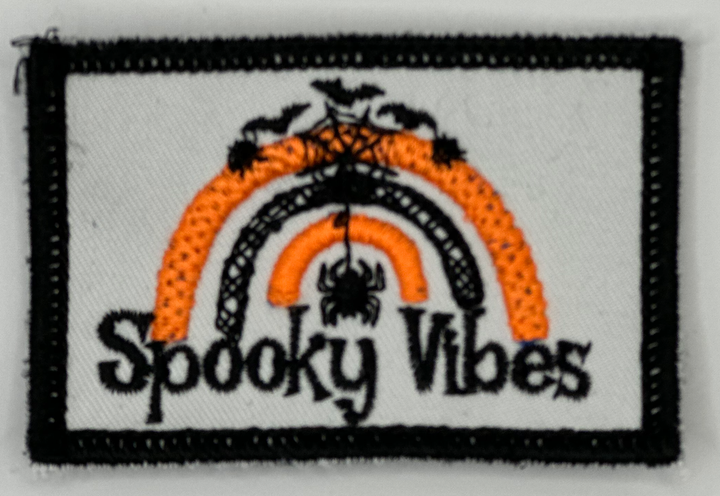 a patch with the words spooky vibes on it