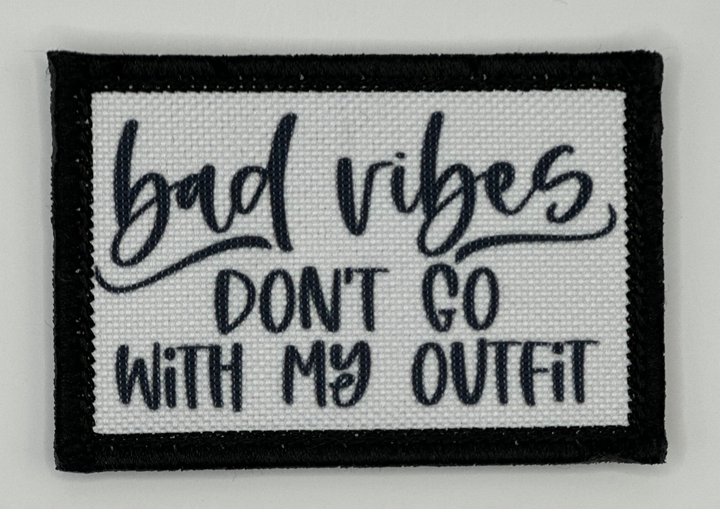 a black and white patch that says bad vibes don't go with my