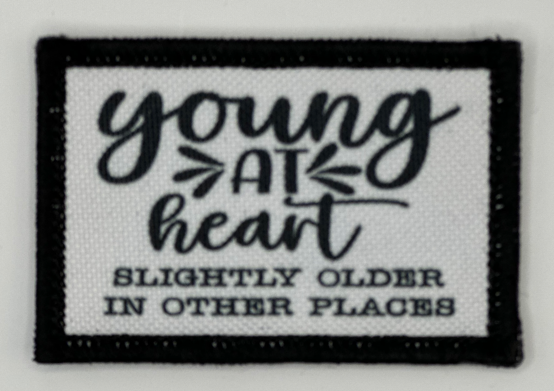 a patch with the words young at heart on it