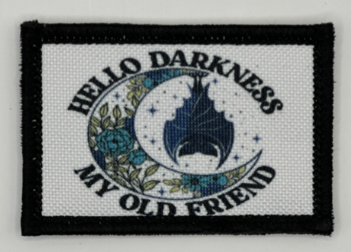 a patch with the words hello darkness, my old friend