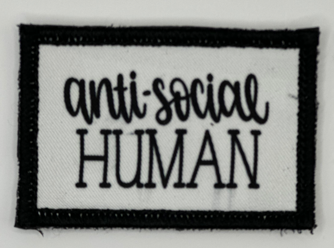 a black and white patch with the words anti - social human on it