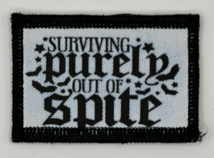 a black and white patch with a saying