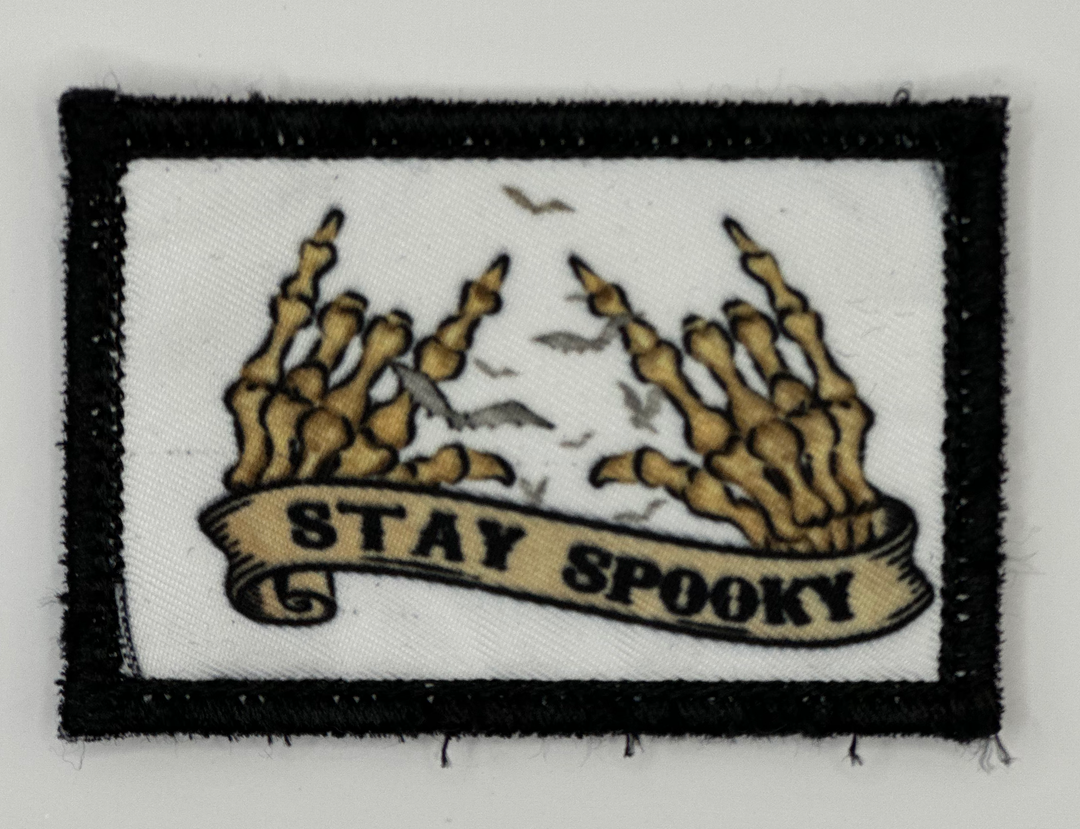 a patch with a banner that says stay spooky
