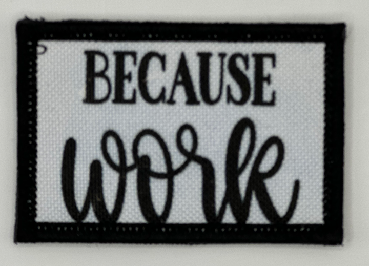 a black and white patch that says because work