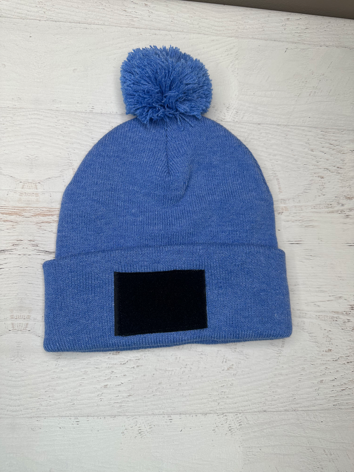 a blue hat with a black square on it