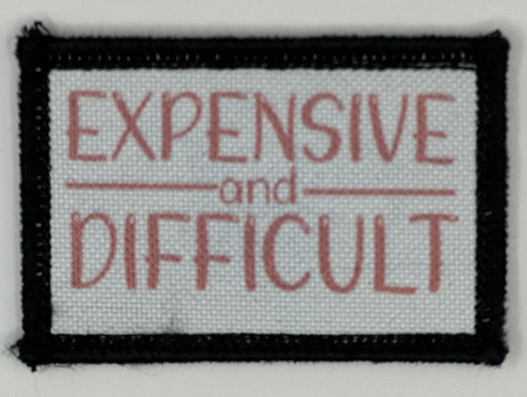 a white and black patch with red words on it