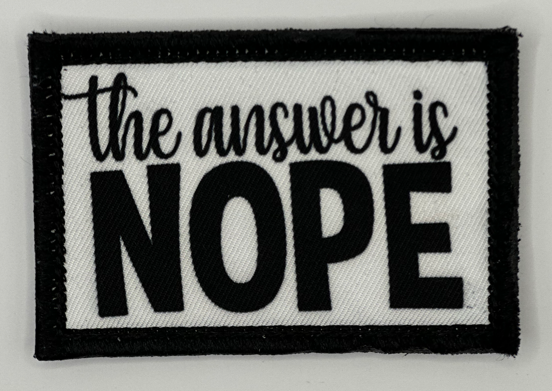 a black and white patch that says the answer is nope