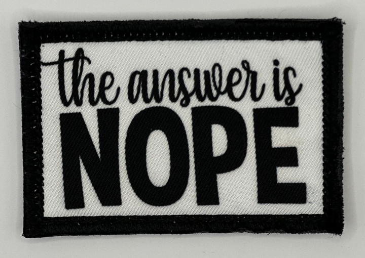 a black and white patch that says the answer is nope