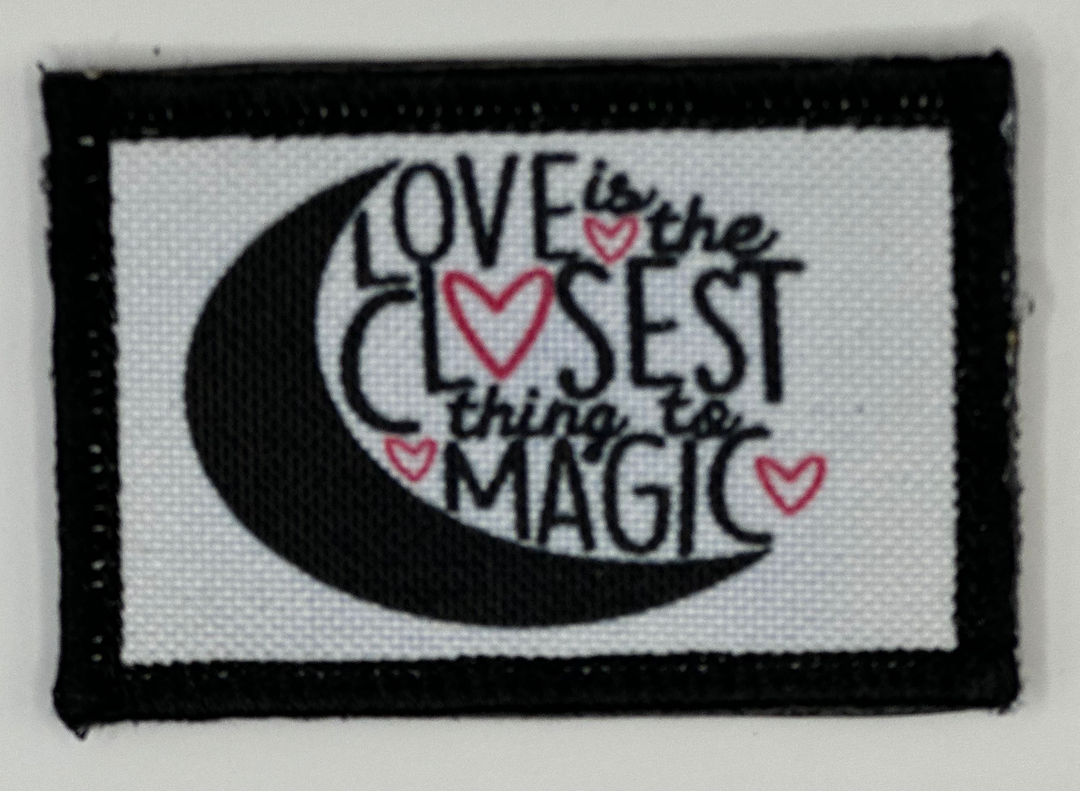 a black and white patch with the words love is the closest thing to magic