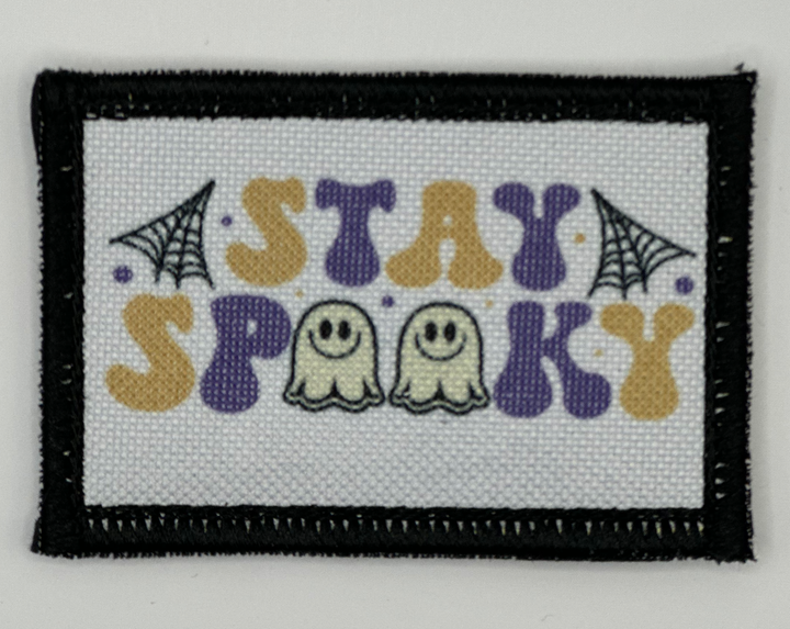 a cross stitch picture of two ghostes with the words stay spook on it