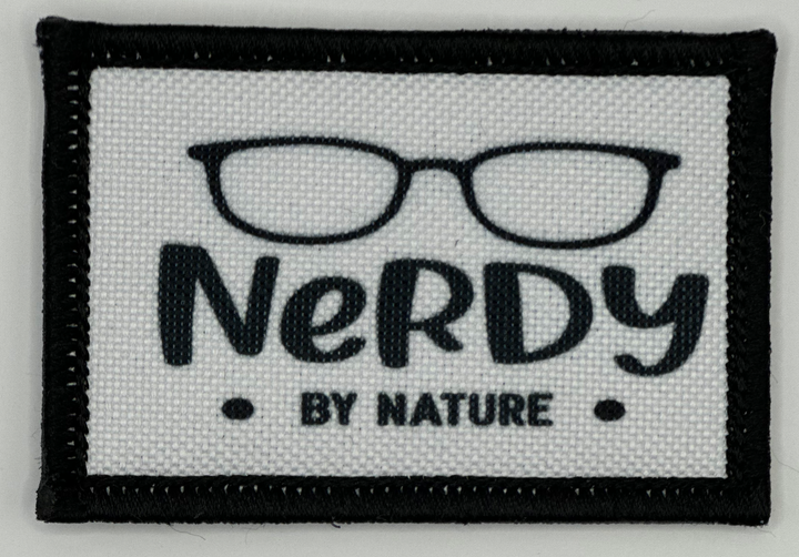 a black and white patch with the words nerdy by nature
