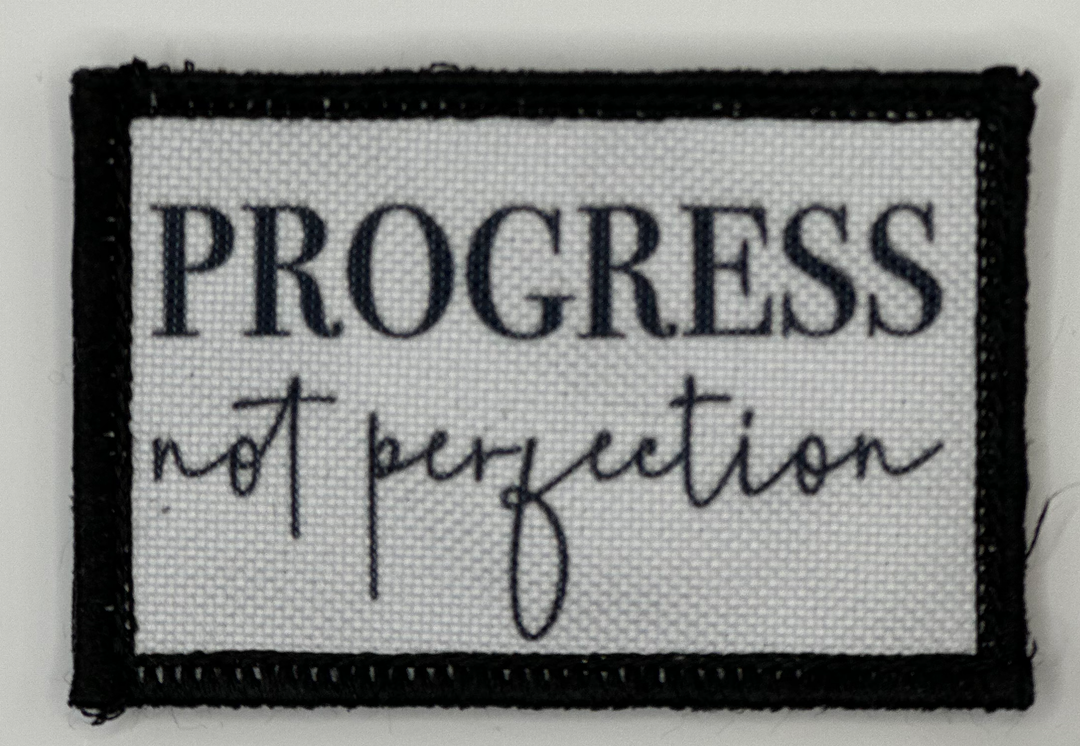 a black and white sign that says progress not projection