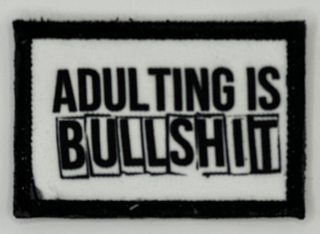 a black and white picture of a sign that says adulting is bullshit