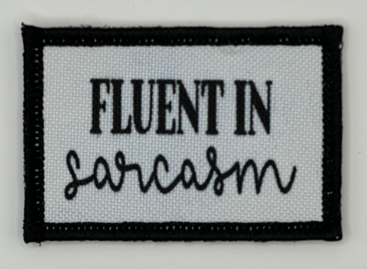 a black and white patch with the words fluent in sarcosm