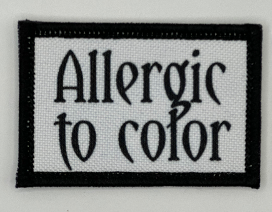 a black and white sign that says, allergic to color
