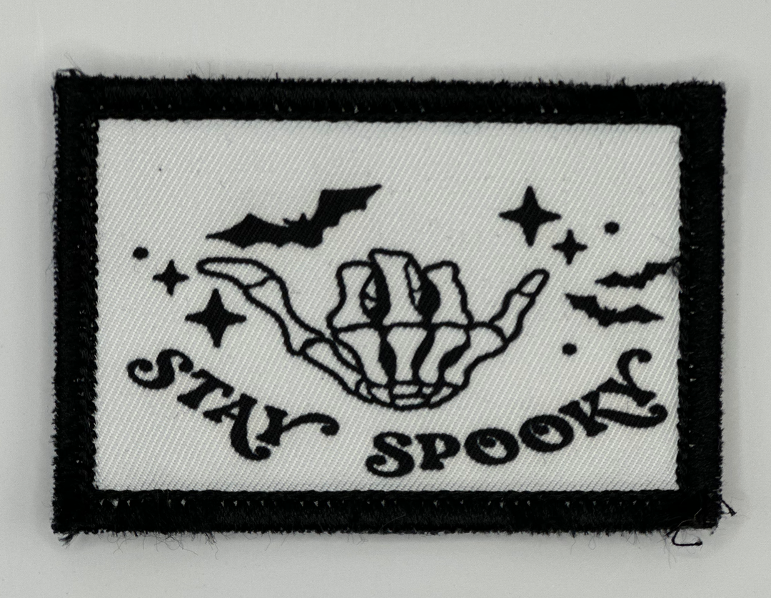 a black and white patch with the words stay spook on it
