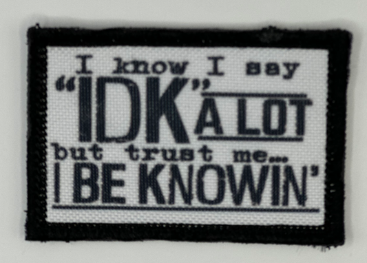 a black and white patch with a quote on it