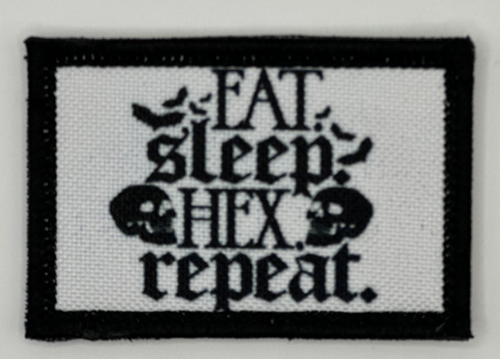 a black and white embroidered patch with the words eat sleep hex repeat