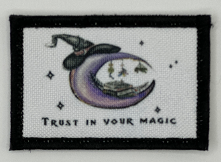 a cross stitch picture of a witch on the moon