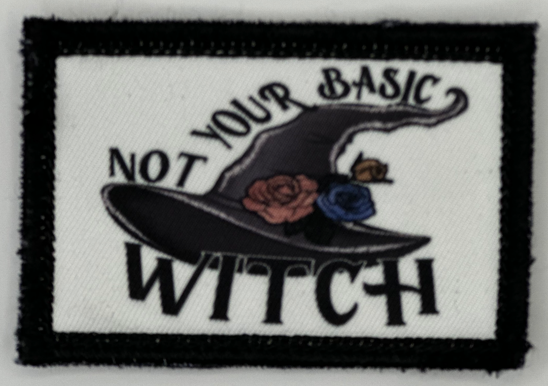 a patch with a witches hat and roses on it